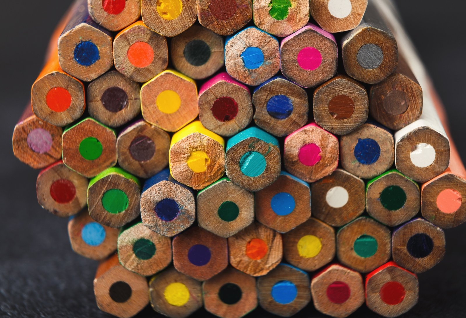 Stack of colorful pencils tips, art background